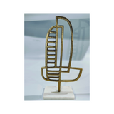 Modern asymmetrical aluminum abstract table sculpture with a metallic finish for hotels, Airbnb properties, furnished apartments, offices, and contemporary interiors.