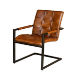 Industrial dining chair with genuine buffalo leather upholstery and a bent iron frame for hotels, Airbnb properties, furnished apartments, restaurants, cafés, and contemporary dining spaces.