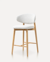 Modern Woody solid ash wood bar stool with an upholstered fabric seat and ergonomic backrest for kitchen islands, hotels, Airbnb properties, furnished apartments, cafés, and contemporary dining spaces.