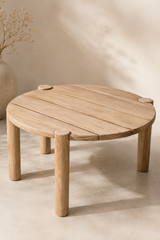 Gent Teak Side Table handcrafted from premium solid teak wood, featuring a round tabletop, four cylindrical legs, natural wood grain, and timeless minimalist artisan craftsmanship.
