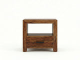 Solid Sheesham wood bedside table with open shelf, drawer, and black handle.