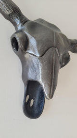 Decorative aluminum bull head wall sculpture with a metallic finish for hotels, Airbnb properties, furnished apartments, offices, and contemporary interiors.