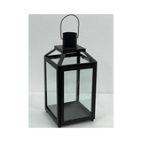 Black iron and glass hanging lantern with a candle holder for hotels, Airbnb properties, furnished apartments, patios, and contemporary interiors.