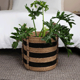 Handwoven black and natural jute storage basket with handles for hotels, Airbnb properties, furnished apartments, bathrooms, bedrooms, and contemporary farmhouse interiors.