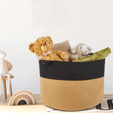 Handwoven black and natural jute storage basket with handles for hotels, Airbnb properties, furnished apartments, laundry rooms, bedrooms, and contemporary interiors.