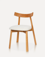 Modern ergonomic solid rubberwood dining chair with an upholstered fabric seat and minimalist design for hotels, Airbnb properties, furnished apartments, restaurants, cafés, and contemporary dining spaces.