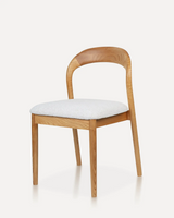 Modern rounded back dining chair with a solid ash wood or rubberwood frame, upholstered fabric seat, and minimalist design for hotels, Airbnb properties, furnished apartments, restaurants, cafés, offices, and contemporary dining spaces.