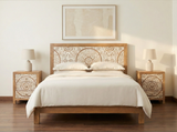 Goa carved mango wood bed displayed in a bedroom