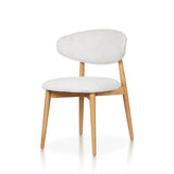 Minimalist Ash Wood Dining Chair handcrafted from premium solid ash wood, featuring a curved backrest, upholstered seat cushion, tapered wooden legs, natural wood grain, and timeless contemporary craftsmanship.