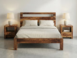 Solid Sheesham wood bed with matching bedside tables in modern bedroom