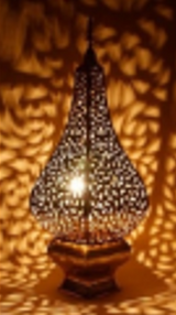 Triangle table lamp with hand-drawn patterned panels creating warm ambient lighting for hotels, Airbnb properties, furnished apartments, meditation spaces, and contemporary interiors.