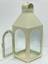 White iron and glass hanging lantern for candles, patios, gardens, hotels, Airbnb properties, furnished apartments, and contemporary interiors.