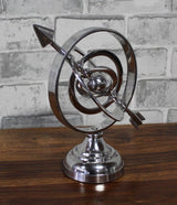 Polished silver armillary sphere decorative sculpture for hotels, Airbnb properties, furnished apartments, executive offices, libraries, and luxury contemporary interiors.